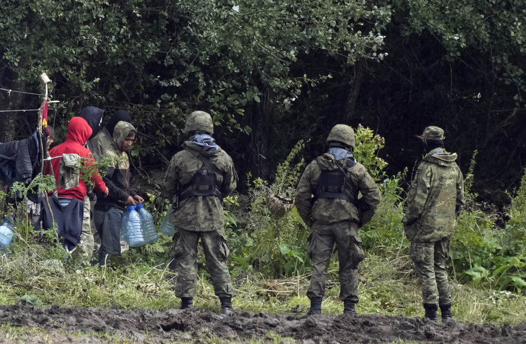 Polska gränsbevakare övervakar migranter vid gränsen mot Belarus i början av september.